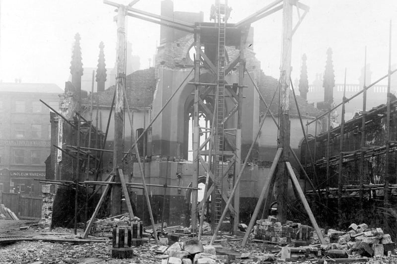 A crane supported by scaffolding during the demolition of the old Roman Catholic St. Anne's Cathedral in October 1904. The building had been designed by architect, John Child and the foundation stone laid on 12th August, 1837. The church opened on October 24, 1838. This view is looking towards Guildford Street (Headrow). Number 2 premises of Peacock and Son Ltd, carpet and textile warehouse is on the left. St. Anne's Cathedral was rebuilt further along Cookridge Street between 1902 and 1904.