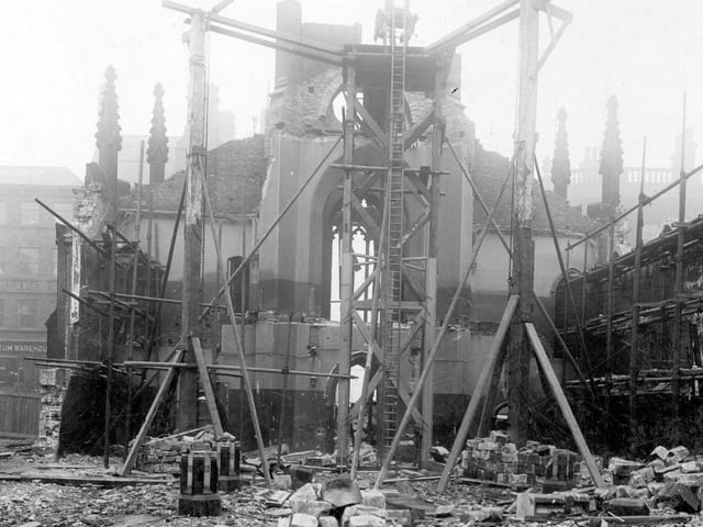 A crane supported by scaffolding during the demolition of the old Roman Catholic St. Anne's Cathedral in October 1904. The building had been designed by architect, John Child and the foundation stone laid on 12th August, 1837. The church opened on October 24, 1838. This view is looking towards Guildford Street (Headrow). Number 2 premises of Peacock and Son Ltd, carpet and textile warehouse is on the left. St. Anne's Cathedral was rebuilt further along Cookridge Street between 1902 and 1904.