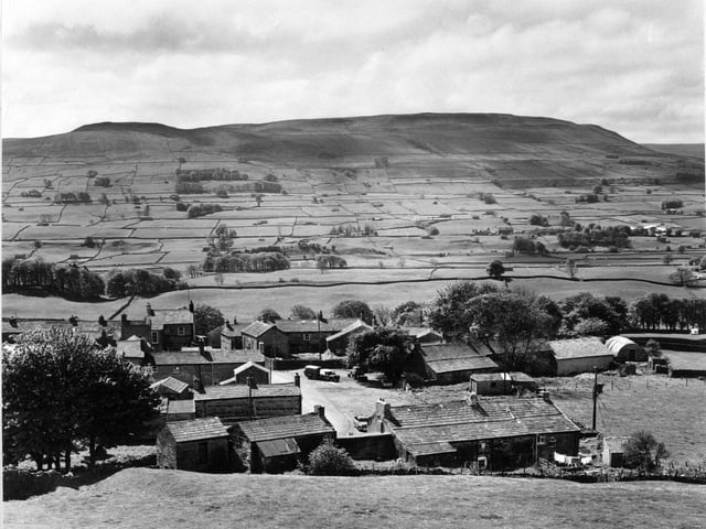 Looking down on the village of Sedbusk near Hawes in Wensleydale in May 1970 with the slopes of Yorburgh rising up at the far side of the valley.