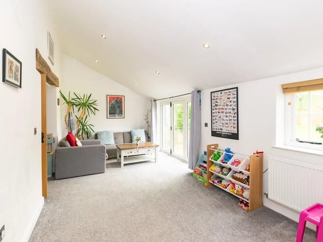 The living area has bifold doors which flood the room with natural light, creating a space to entertain and opening out to the rear garden.