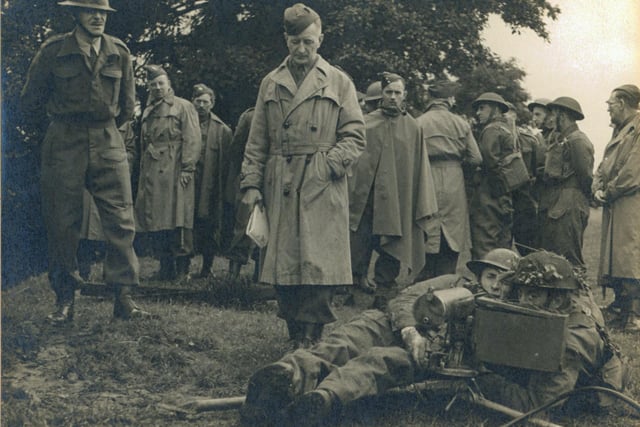 The Machine Gun detachment during inspection. Possibly at Golden Acre as the Leeds Sub-area School of Tactics taught hundreds of officers and senior NCOs in Golden Acre Park (Yorkshire Post & Leeds Intelligencer 1/11/44). In his account of the 9th Battalion written in September 1945, Commanding Officer Lt Col HK Boyle DSO writes about these weekend schools where Tactics, Weapon Training, Bombing, Intelligence, Gas, Street Fighting, Umpiring, Ammunition, Catering, Hygiene and Civil Defence were taught - 'three very full and concentrated week-ends on top of a full time civilian job, though, proved very gruelling to most of those who undertook this'. The soldiers in macs were possibly American Officers.