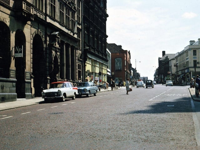 Queen Street shows a new building for the Midland Bank having replaced the single storey structure. This has also absorbed the Blue Ribbon coffee tavern. The single storey cottages just before Albion Street have been replaced by the 1899 three storey Co-op building. This cuts off any view of the site of the Manor House and what replaced it. Similarly there is nothing visible of any buildings down Hope Street. The Queen's Hotel is no longer prominent as it has been reduced from four to two storeys. The part of Wesley Street Mill adjoining Queen Street has also been knocked down as have old shops beyond Albion Street.