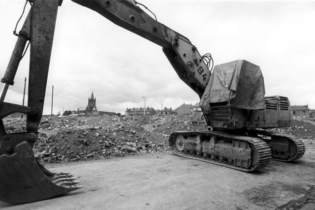 A cleared area beside Armley's St. Bartholomew's Church, which is visible in the background. Possibly looking from Fitzarthur Street, from where a digger is seen in the foreground. Streets in this area were demolished in the early 1980s.