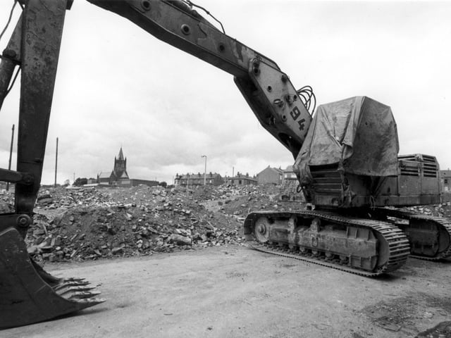 A cleared area beside Armley's St. Bartholomew's Church, which is visible in the background. Possibly looking from Fitzarthur Street, from where a digger is seen in the foreground. Streets in this area were demolished in the early 1980s.