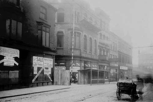 Call Lane in March 1910.; Empty business premises to make way for New Market Street improvement. Premises shown were at number 22 Call Lane James Skelton, then at number 20 Cash Boot Co. Next is the passage leading to New Market Street with Globe boot stores to the right of that at number 16. Number 14 was formerly Jackson's Stores Ltd house furnishers.