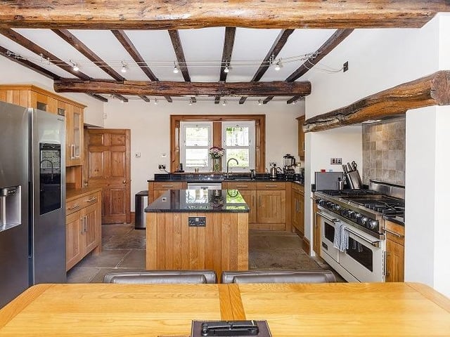 The dining kitchen has oak units with granite work tops. It includes a breakfast island, and a Viking oven with gas hob and hot plate.