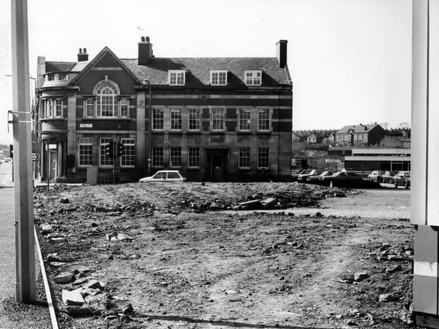 The old Police Station and Library at the junction between Dewsbury Road and Hunslet Hall Road, from across a stretch of barren land in April 1982.
