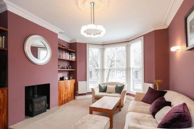 This spacious, yet cosy living room is bolstered by the warm colours on the walls.