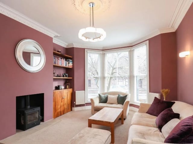 This spacious, yet cosy living room is bolstered by the warm colours on the walls.