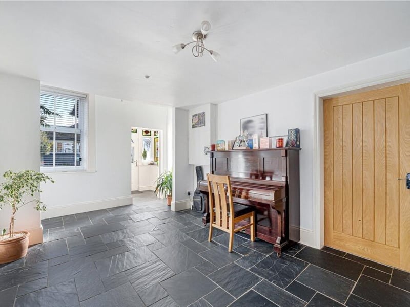 A welcoming porch opens into a large, wide hallway, setting the tone for the generous proportions found throughout the house.