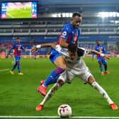 Crystal Palace's French-born Ghanaian striker Jordan Ayew (L) fights for the ball with Leeds United's Brazilian midfielder Raphinha during the English Premier League football match between Crystal Palace and Leeds United at Selhurst Park in south London on November 7, 2020. (Photo by Glyn KIRK / POOL / AFP) / RESTRICTED TO EDITORIAL USE. No use with unauthorized audio, video, data, fixture lists, club/league logos or 'live' services. Online in-match use limited to 120 images. An additional 40 images may be used in extra time. No video emulation. Social media in-match use limited to 120 images. An additional 40 images may be used in extra time. No use in betting publications, games or single club/league/player publications. /  (Photo by GLYN KIRK/POOL/AFP via Getty Images)