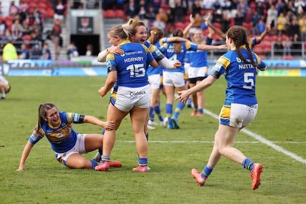 Rhinos players celebrate their 2022 Betfred Women's Super League Grand Final win over York. Picture by John Clifton/SWpix.com.