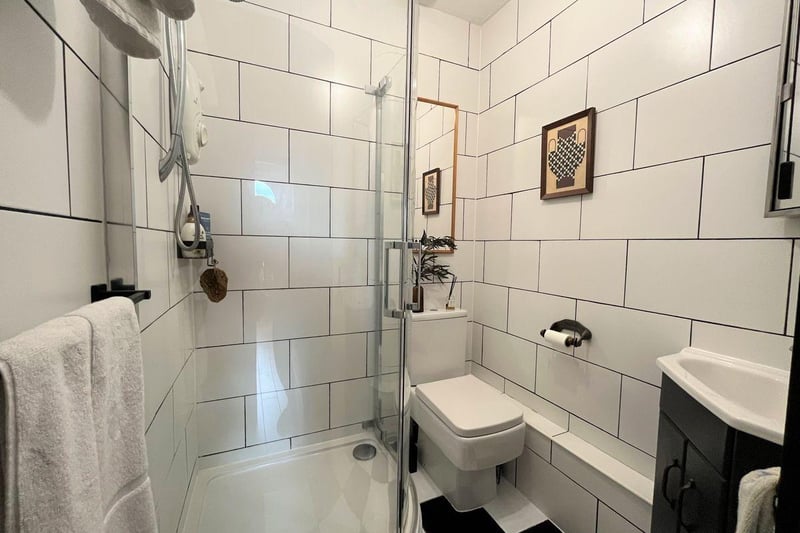 The fully tiled shower room has modern fixtures and fittings and comprises; corner shower cubicle with electric shower, hand basin and w.c.