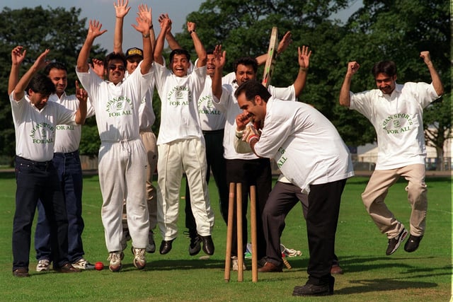Howzat! Councillor Javed Akhtar, organiser of the "Asian Sport for All" cricket tournament on Soldiers Field in August 1997 is clean bowled, as competitors in the competition celebrate.
