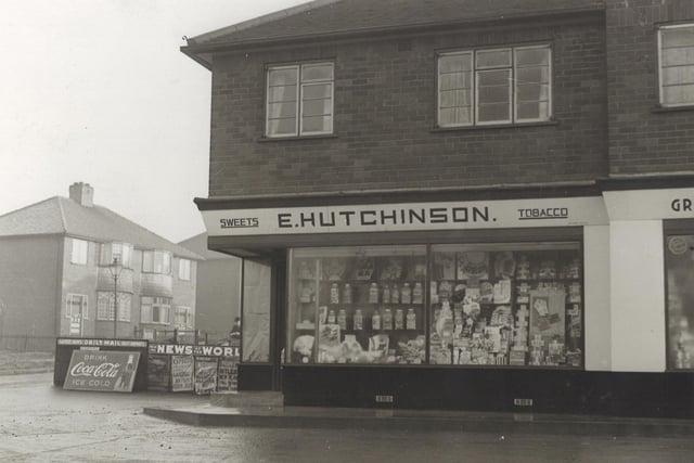 A shop selling newpapers, sweets, tobacco on the corner of Heath Grove opposite Leeds United football ground. To the left are placards with headlines from the newspapers, also advertisement for Coca-Cola. Pictured in January 1940.