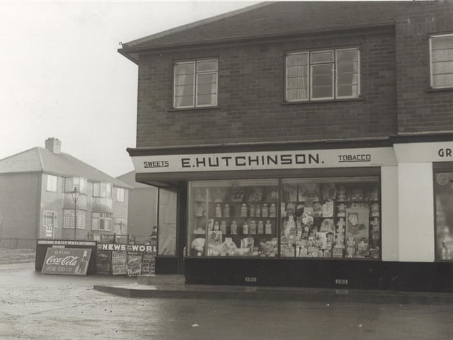 A shop selling newpapers, sweets, tobacco on the corner of Heath Grove opposite Leeds United football ground. To the left are placards with headlines from the newspapers, also advertisement for Coca-Cola. Pictured in January 1940.