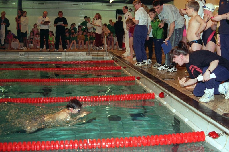 Simon Goldie from Pudsey Bolton Royd Primary, gets encouragement from his teacher Kate Prior during the Boys Year 3/4  4x25m Freestyle Relay in The Swimsafe Schools Teams Swimming Gala held at Armley Sports Centre in March 1997.