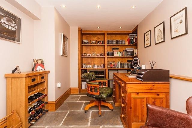 This office has bespoke fitted shelves and space for a fridge.