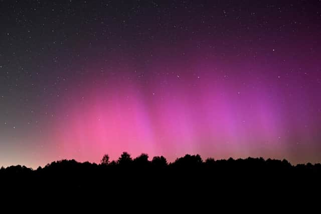 The Northern Lights illuminate the night sky.
