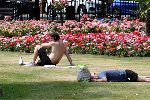 People enjoy the sunshine in Park Square, Leeds, as the country sweltered in the heatwave on July 19.