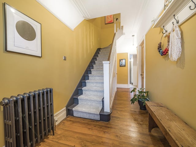 Typical for a house of this age, there is a grand entrance hall upon entry at the front of the house. There is an original wooden floor, as well as a solid wooden door with stained glass window.