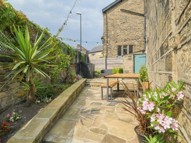 Outside, the garden has a generous stone patio area which enjoys a south facing aspect and is the perfect entertaining and relaxing space.