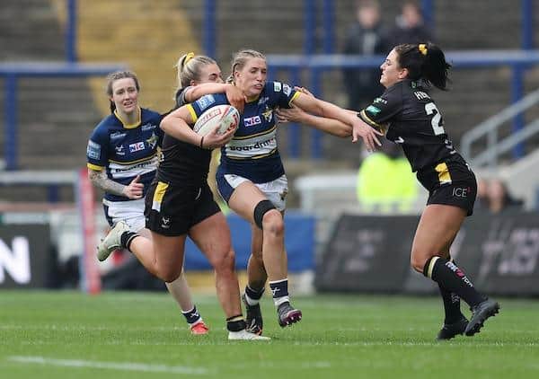 Rhinos' Caitlin Beevers tries to get clear of York's Tamzin Renouf and Ellie Hendry. Picture by John Clifton/SWpix.com.