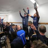 On the up: Leeds Tykes players and staff celebrate in the changing rooms after their promotion to National One was confirmed. Picture courtesy of Mike Inkley.