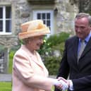 Visiting the set of Emmerdale in 2002. The Queen and Duke of Edinburgh's visit to Harewood House and the Emmerdale set. The Queen meets Emmerdale actor Chris Chittell, right, and Emmerdale Line Producer Tim Fee.