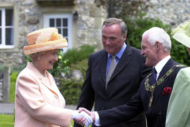 Visiting the set of Emmerdale in 2002. The Queen and Duke of Edinburgh's visit to Harewood House and the Emmerdale set. The Queen meets Emmerdale actor Chris Chittell, right, and Emmerdale Line Producer Tim Fee.