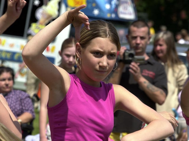 Adele Healey, a member of the Flash Community Dance Group, entertains the visitors at the Beeston Festival and Mela at Cross Flatts Park in June 2003.