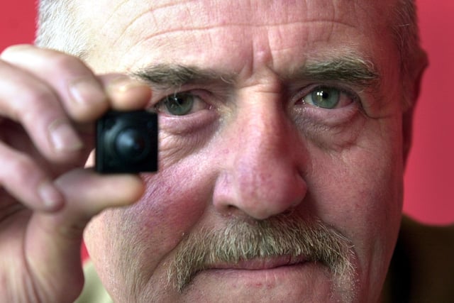 Dave Allan with a tiny surveillance camera available at The Spy shop on Kirkstall Road in April 2002.