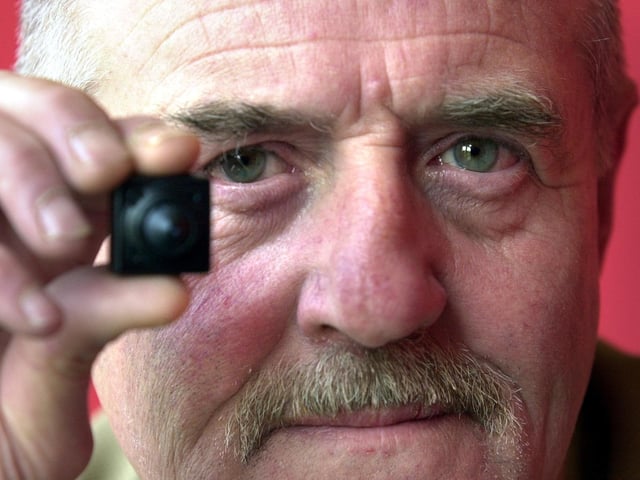 Dave Allan with a tiny surveillance camera available at The Spy shop on Kirkstall Road in April 2002.