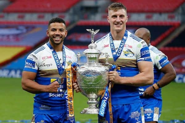 Kruise Leeming, left, celebrates Rhinos' 2020 Chal;lenge Cup win with then-teammate Alex Mellor. Picture by Ed Sykes/SWpix.com.