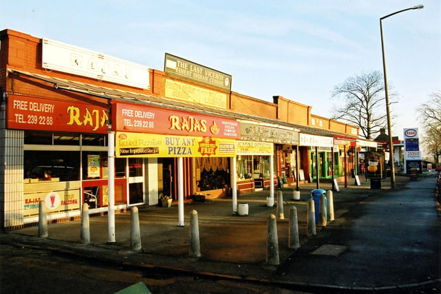 Shops and restaurants on Harrogate Road in 2003. On the left is Rajas Take-away, serving a range of cooked foods, including nan kebab, pizzas, Chinese, Tandoori. Next right, number 48 is the Last Viceroy Indian restaurant.