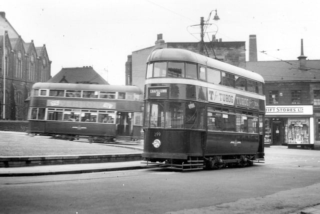 A view showing former Southampton tram, no.299, entering Stainbeck Lane from the junction with Harrogate Road, known as Stainbeck Corner. Another tram is seen towards the left. In the background are the Wesleyan Methodist Church on the left and Thrift Stores Ltd. on the right. Pictured in July 1951.