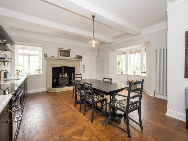 The high spec, fitted dining kitchen with bay window has a feature fireplace with warming stove.
