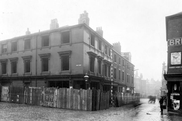 A view of derelict buildings on corner of Wade Street with Woodhouse Lane. St Ann Street is on the right. Pictured in August 1906.