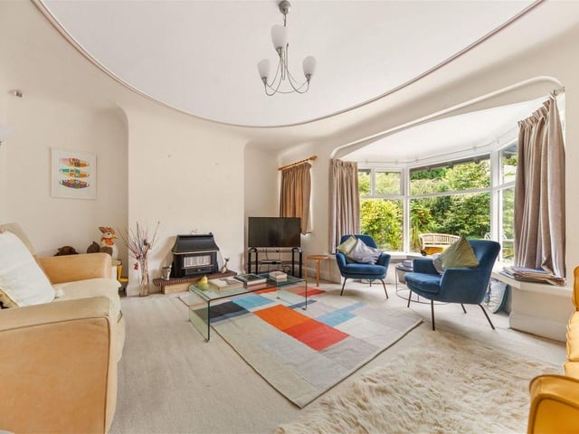 The living room is elegant and bright: A huge bay window floods the room with natural light and accentuates the traditional features