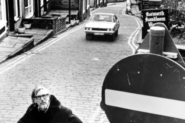 Mr. Walls looks up at one of the no entry signs prematurely unveiled on Main Street ion January 1975.