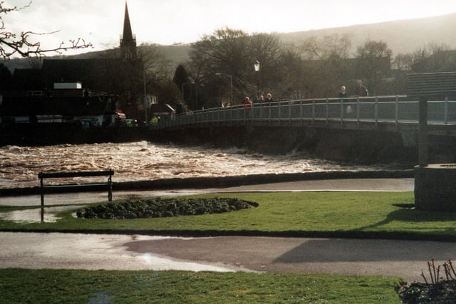Floody hell! River Wharfe and Bridge Street bridge in April 2002. In foreground is a paving and grassed area showing evidence of flooding, visible on the right is a well. The church in the distance is Bridge Street United Reform Church.