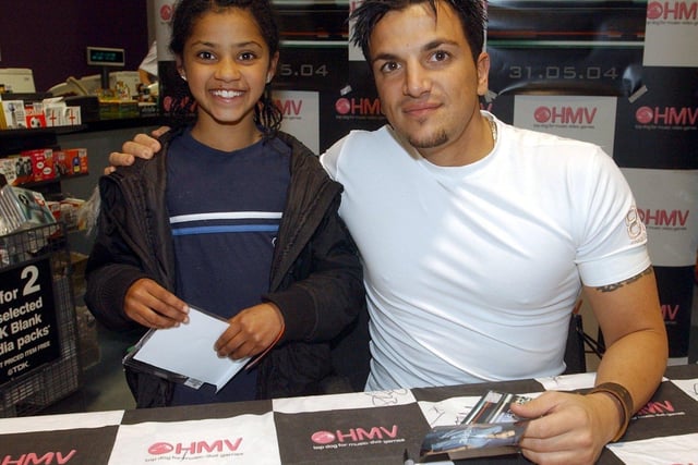 Popstar Peter Andre visits HMV store in Leeds city centre to sign copies of his new CD Insania. Pictured with young fan, Najma Mahmood, aged 9, from Chapeltown, Leeds on June 3, 2004.