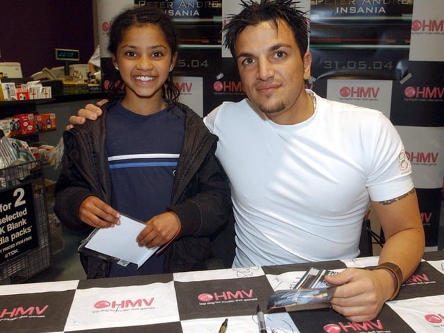 Popstar Peter Andre visits HMV store in Leeds city centre to sign copies of his new CD Insania. Pictured with young fan, Najma Mahmood, aged 9, from Chapeltown, Leeds on June 3, 2004.