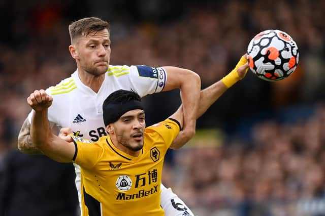 LEEDS, ENGLAND - OCTOBER 23: Liam Cooper of Leeds United battles for possession with Raul Jimenez of Wolverhampton Wanderers during the Premier League match between Leeds United and Wolverhampton Wanderers at Elland Road on October 23, 2021 in Leeds, England. (Photo by Michael Regan/Getty Images)