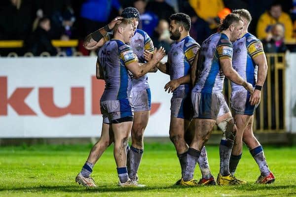 Lachie Miller, left of picture, celebrates with teammates after scoring for Leeds Rhinos in the win at Castleford Tigers. Picture by Allan McKenzie/SWpix.com.