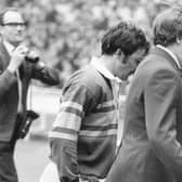 Syd Hynes, left,  is escorted from the field by Leeds colleague Alan Smith after being sent off in the incident with Alex Murphy at Wembley in 1971.