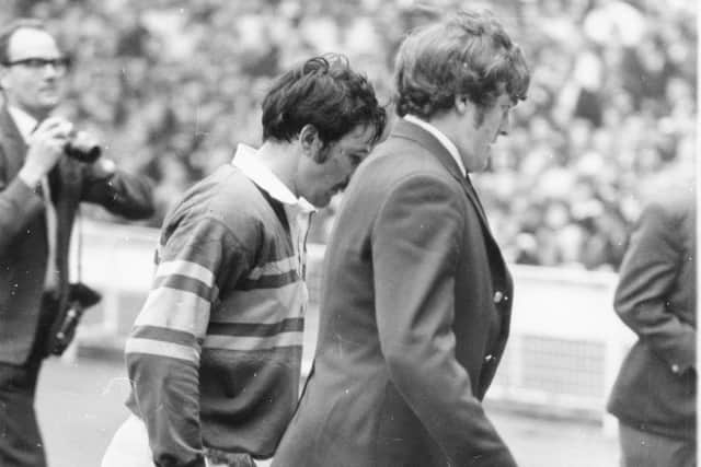 Syd Hynes, left,  is escorted from the field by Leeds colleague Alan Smith after being sent off in the incident with Alex Murphy at Wembley in 1971.