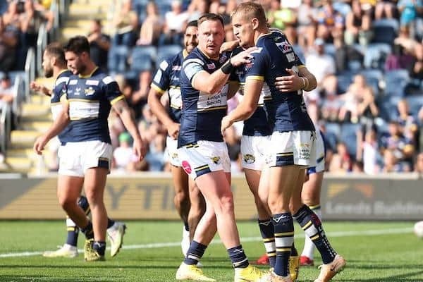 Luke Hooley, right, celebrates after scoring for Rhinos during their Headingley win over Warrington in August. Picture by John Clifton/SWpix.com.