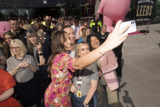 Shoppers take a selfie as they wait for the official unveiling