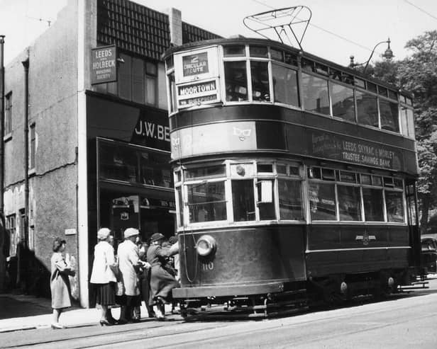 A view showing Chamberlain tram no.110, on route 2 to Moortown, stopping to pick up passengers on Harrogate Road. To the left of the photo is no.51 Harrogate Road, which is home to J.W. Bennett radio and the Leeds and Holbeck Building Society, by the junction with Club Row. To the right is Stainbeck Corner, the junction with Stainbeck Lane, with the edge of the Yorkshire Penny Bank just seen on the far right. Pictured in June 1951.